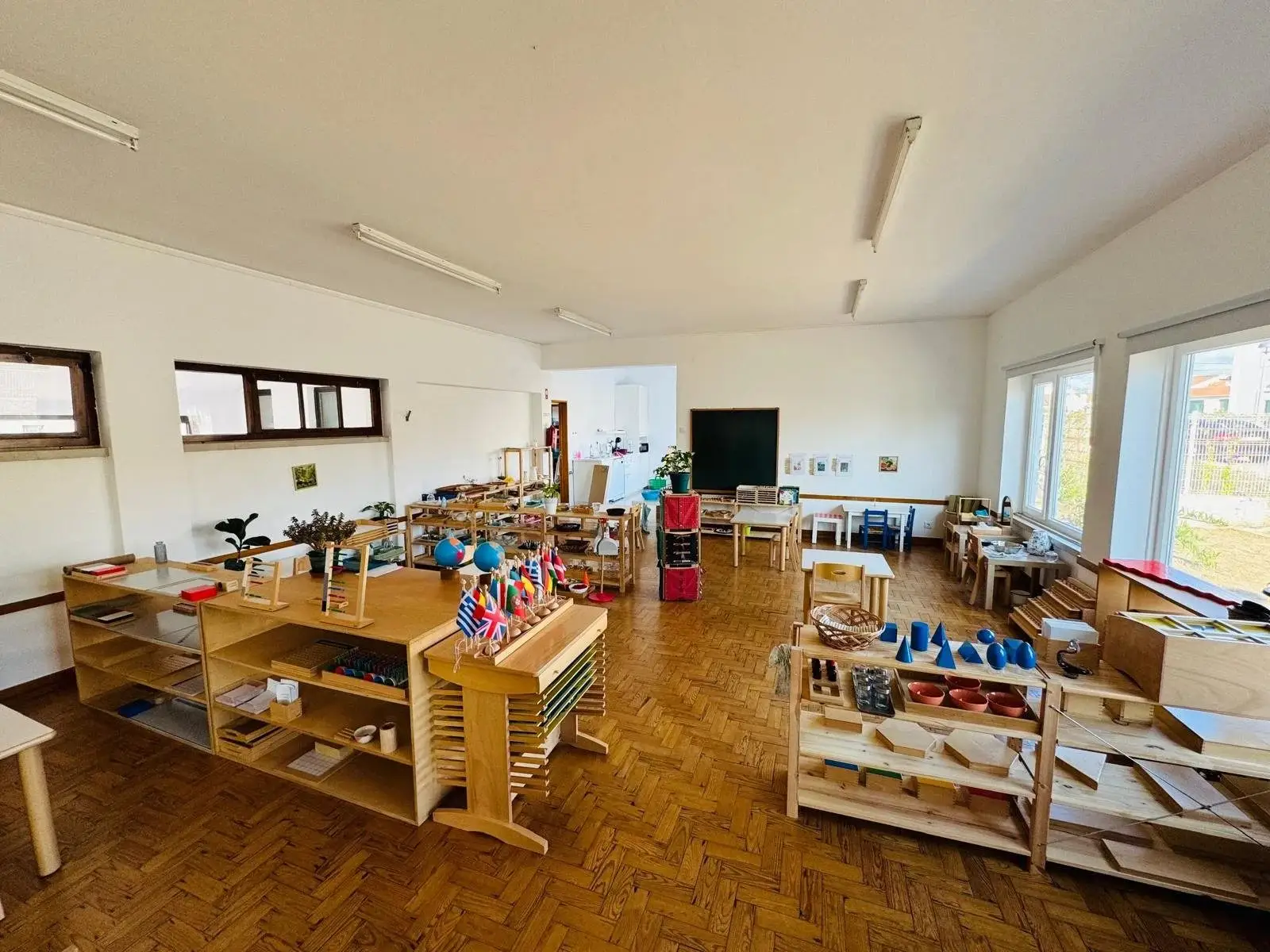 Montessori classroom with low wooden shelves of learning materials at Montessori HUMANS
