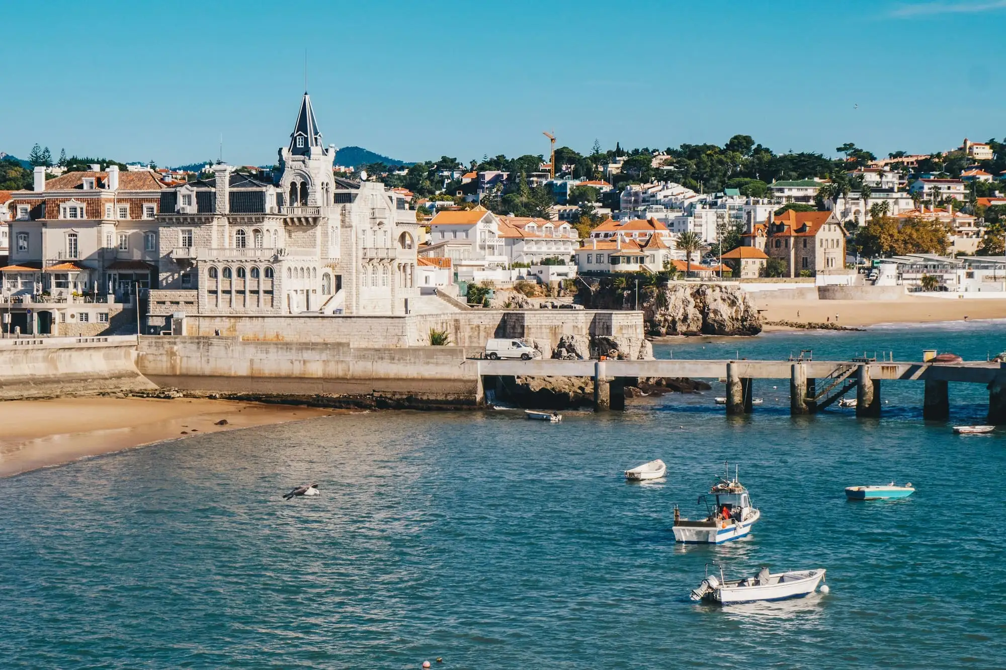 Boats in the bay below Cascais old town on a sunny day